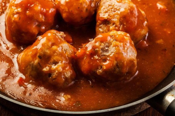 Meatballs with tomato sauce on pan