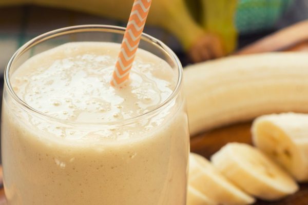 Fresh made Banana smoothie on wooden background