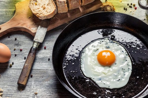 Fried egg on a pan served with homemade bread