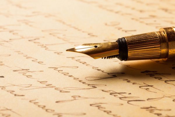 Fountain pen on an antique handwritten letter