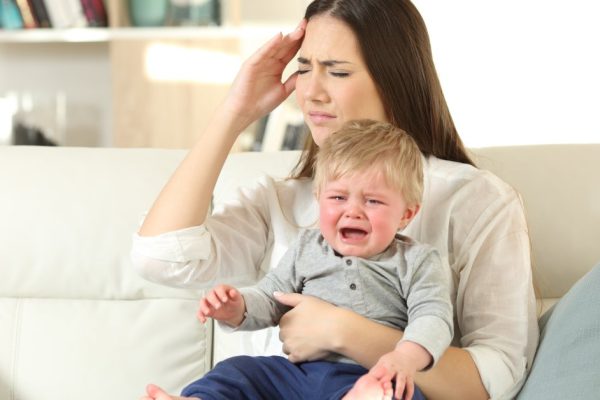 Mother suffering and baby crying desperately
