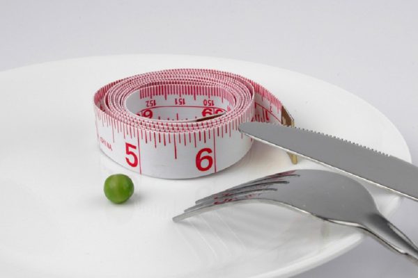 Measuring Tape and pea on a plate diet