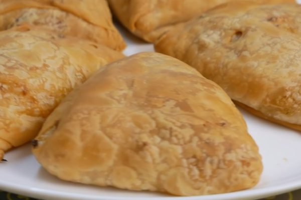 Циганка шинкует капусту и замешивает свежее тесто, чтобы приготовить постную самсу