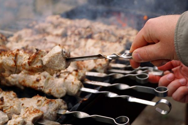 Delicious meat kebabs on skewers on the grill