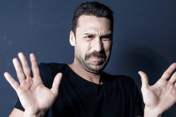 Man with moustache showing a disgusted facial expression