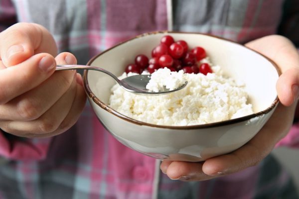 Closeup of woman holding bowl with healthy breakfast