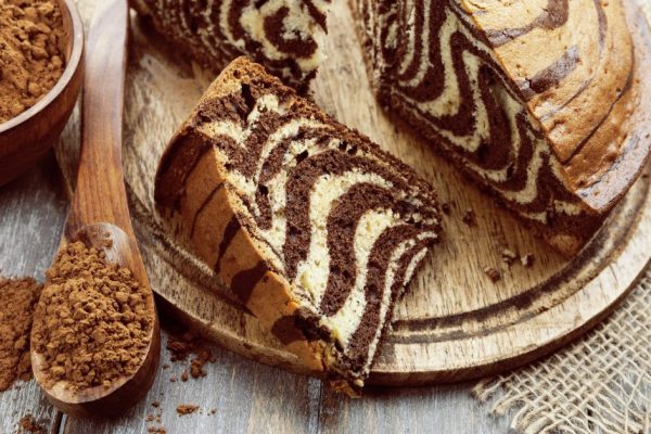 Cake with cocoa  powder on the wooden table