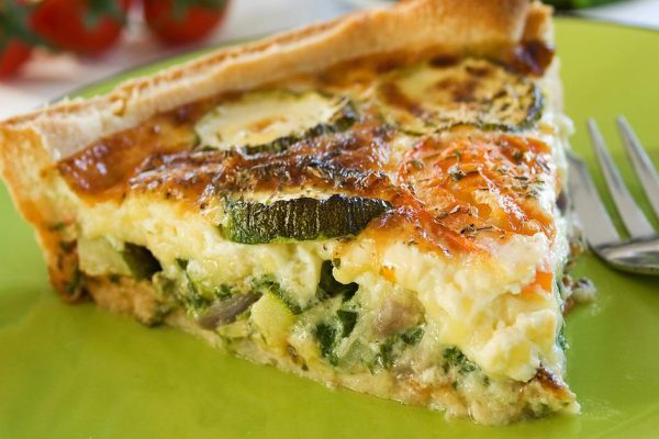 A sliced portion of Zucchini quiche on a plate