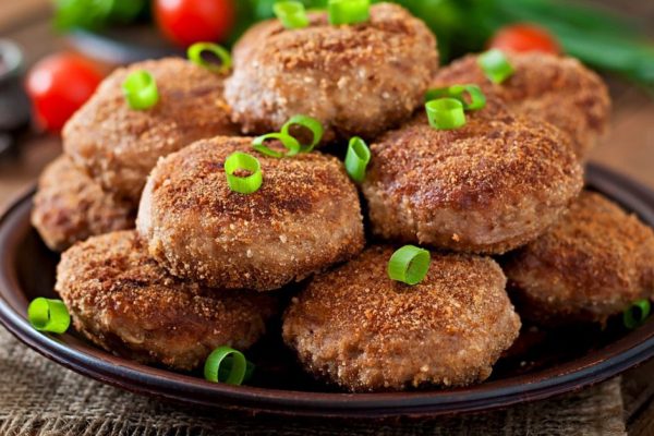 Juicy delicious meat cutlets on a wooden table