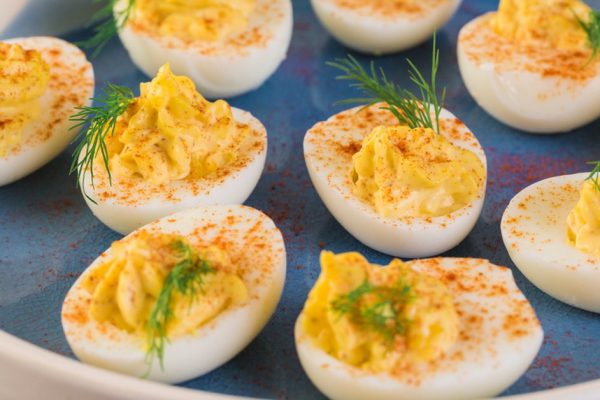 Deviled eggs garnished with fresh dill.
