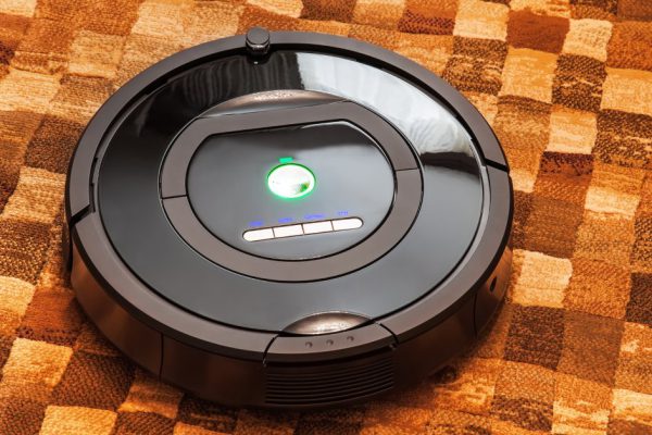 Robotic vacuum cleaner on carpet - technology housework