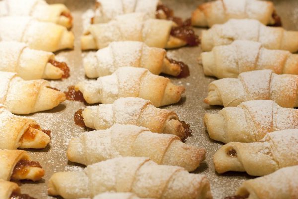 Homemade freshly baked croissants with jam on a baking