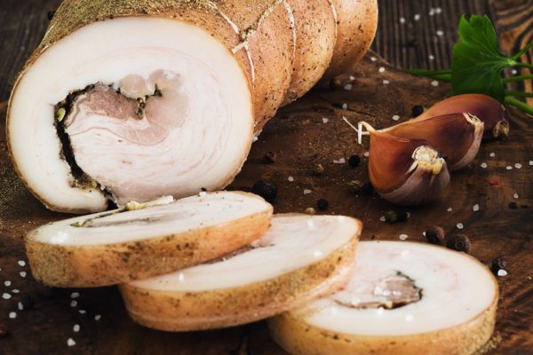 Lard roll with salt and garlic, wooden background