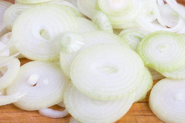 Sliced onion on a wooden board