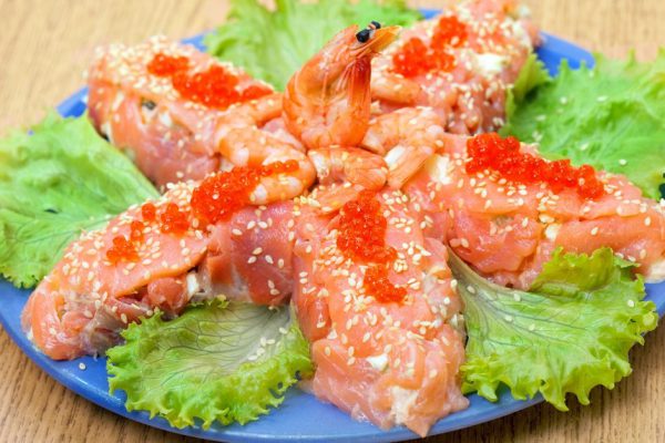 Salad with salmon fish and red salmon caviar