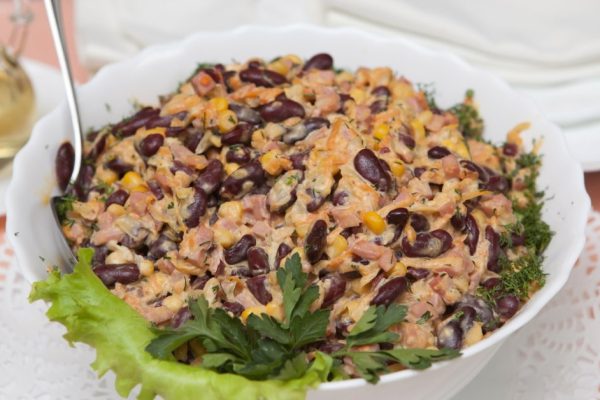 Salad. Haricot, corn, ham, mayonnaise, salad leaves, parsley and fennel as ingredients.