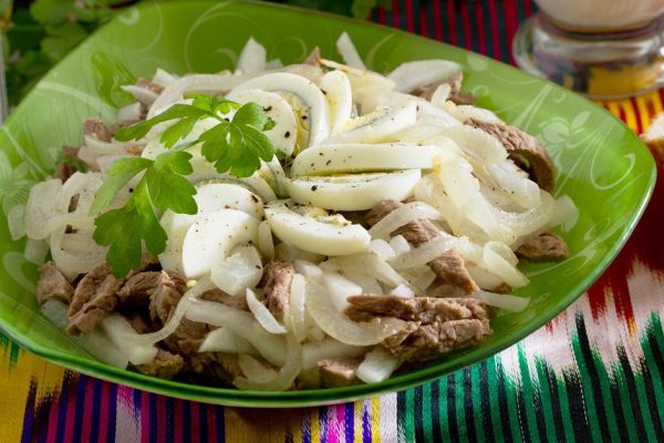 Fresh salad with beef, green radish, onion and eggs - Tashkent. The traditional dish of Uzbek cuisine.