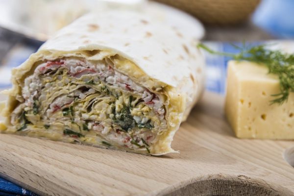 Roll on a wooden table. Delicious cold appetizer .