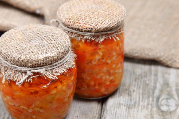 Canning vegetables in the banks on wooden background