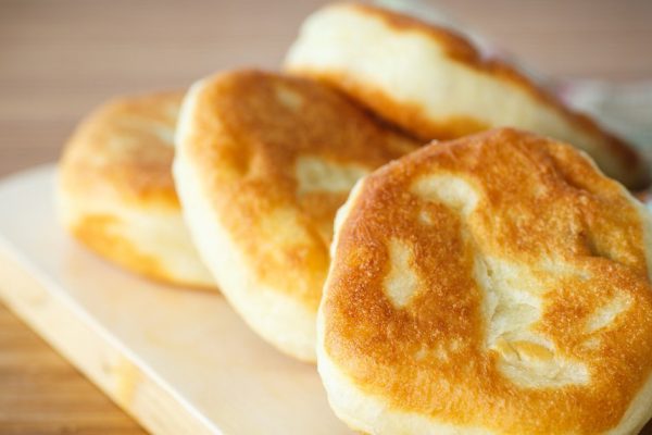 fried pastry stuffed with on a wooden table