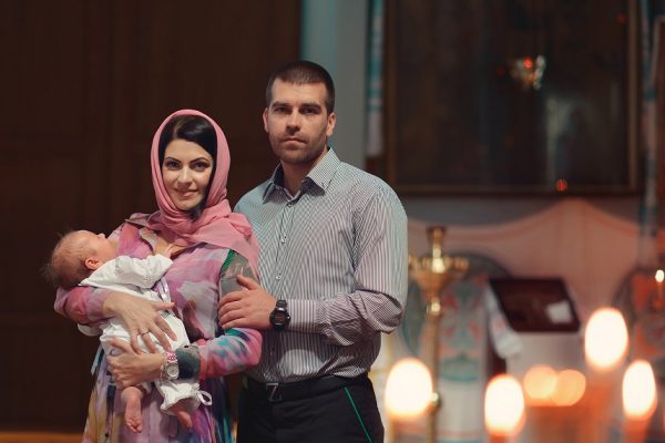 in the church baptized young family with a small child in her arms