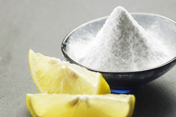glass container with heap of baking soda