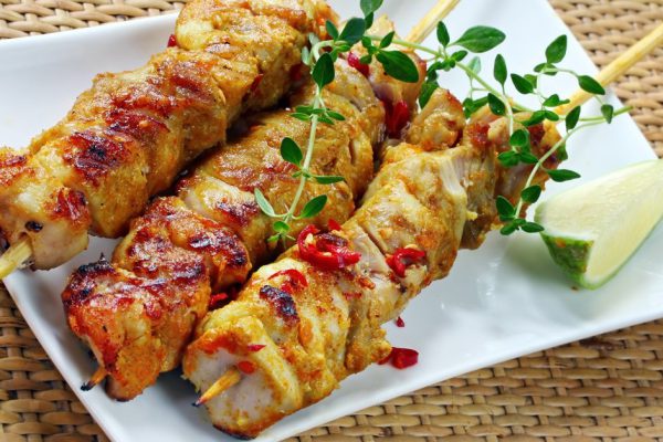 Chicken skewers served with chili, lime, thyme, and a chili dipping sauce.