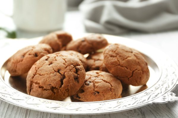 Tray with tasty homemade cookies on kitchen table, closeup