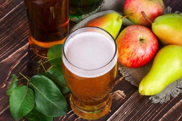 Apple and pear cider glass and bottles with fruits