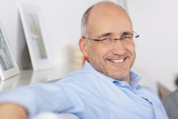 Close up portrait of happy mature man indoors