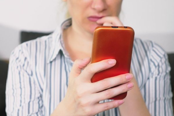 woman uses smartphone. woman read bad news in smartphone