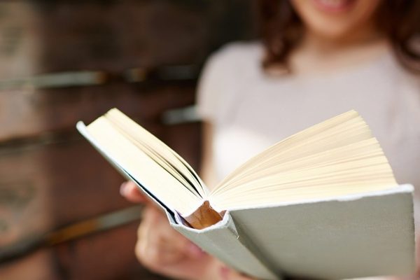 Young woman reading book
