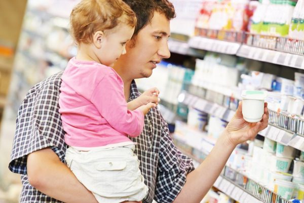Shopping. Father man and little child girl choosing dairy products in shop supermarket