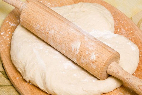 Yeast dough preparation - dough, rrolling pin,breadboard