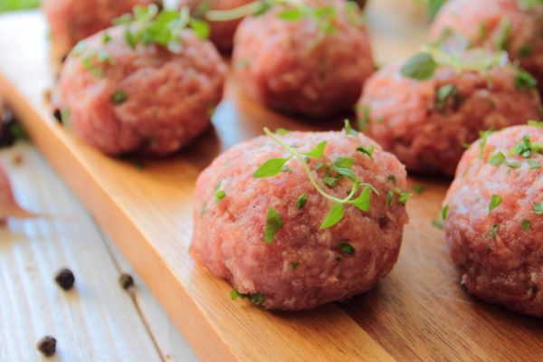 Fresh raw meat balls with herbs