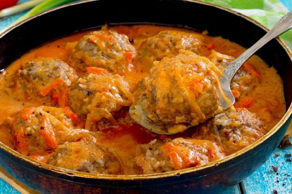 Homemade meatballs in tomato sauce with basil and spices in a frying pan