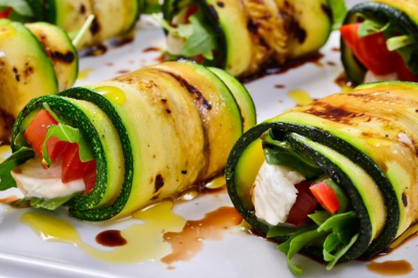 grilled zucchini with tomato, arugula and mozzarella cheese, drizzled with olive oil and balsamic vinegar