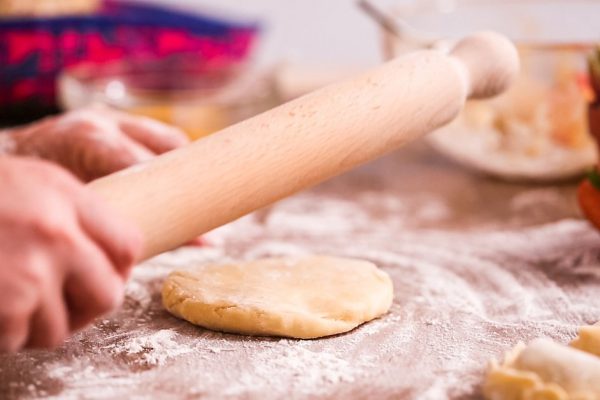 Step by step. Rolling dough for home made empanadas.