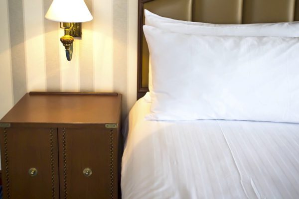 Night scene in hotel room, nightstand with lamp