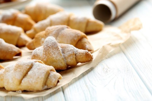 Fresh homemade croissants on a blue wooden table