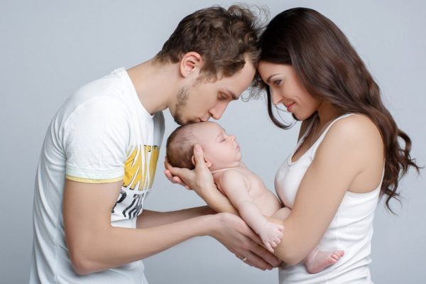 mom dad and baby. Loving parents with their cute little son