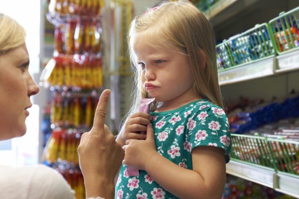 Child Having Arguement With Mother At Candy Counter