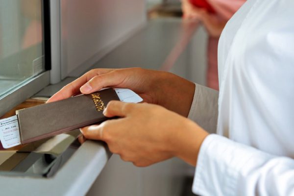 Woman buying tickets with passport at box office