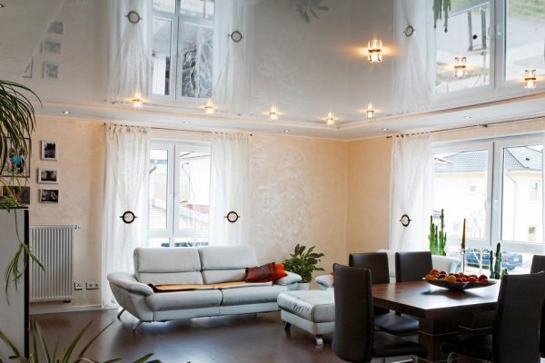 Living room with halogen lighting on a PVC ceiling.
