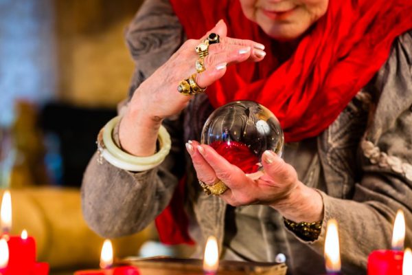 Female Fortuneteller or esoteric Oracle, sees in the future by looking into their crystal ball