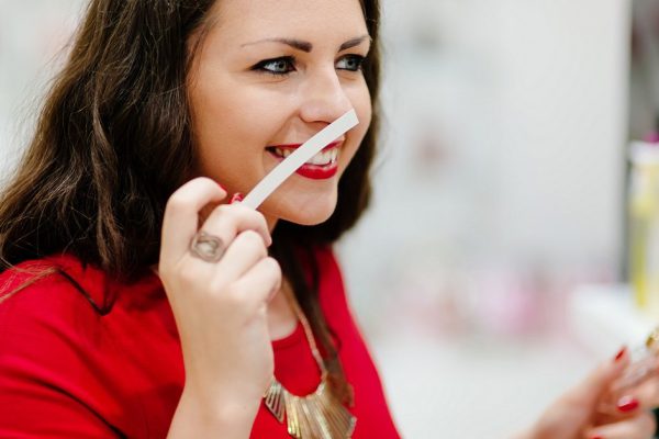 Happy woman testing new  fragrances