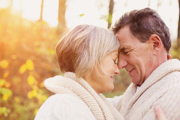 Active seniors on a walk in autumn forest