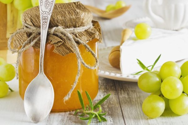 grape jam in a glass jar, brie cheese and ripe grapes.health and diet food.traditional food