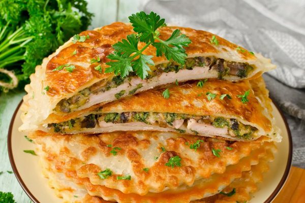 Meat with mushrooms, cheese and herbs baked in crispy dough