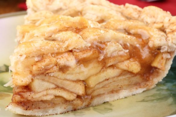 Piece of sliced apple pie on a plate